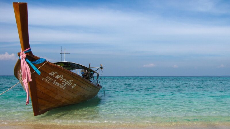 Long-tail Boat on Beach — Blue, Serene, Afternoon, Photograph, Ocean
