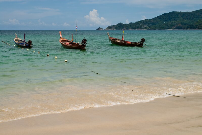 Long-tail boats at a tropical beach
