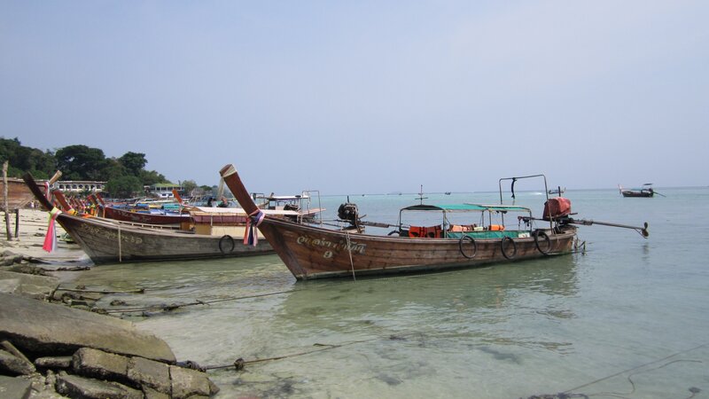 Long-tail boats at a tropical beach