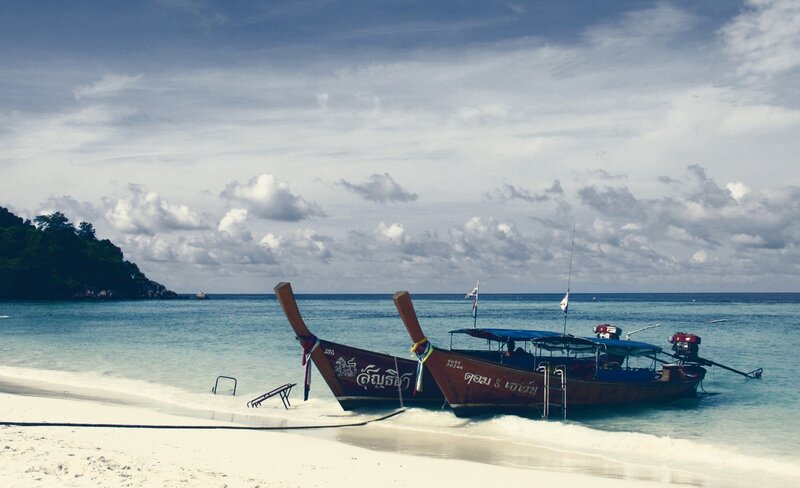 Long-tail boats on a tropical beach