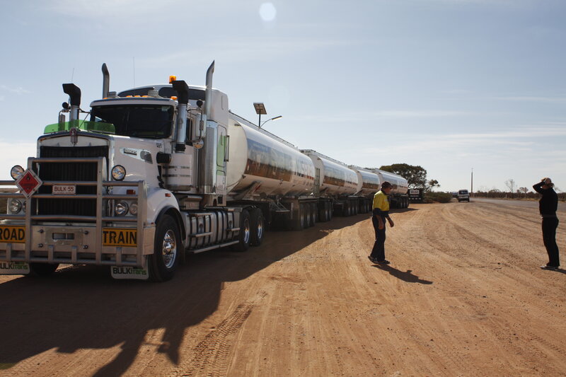 Long tanker truck on dirt road