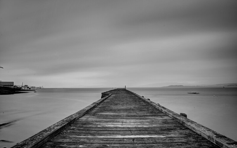 long wooden pier extending into sea