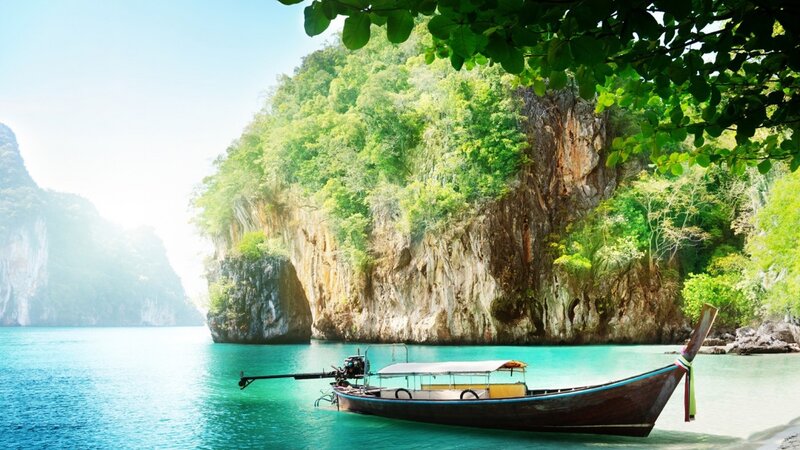 Longtail Boat in Bay — Blue, Serene, Afternoon, Photograph, Cliffs, Trees, Sea