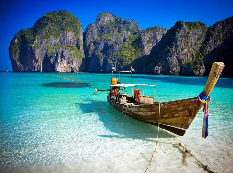 Longtail Boat in Turquoise Water — Blue, Serene, Afternoon, Photograph, Cliffs