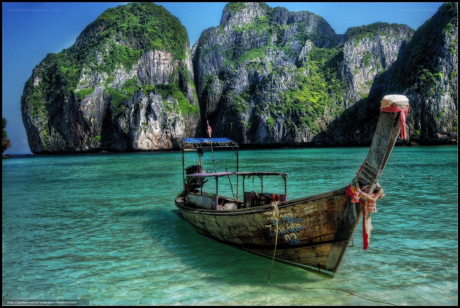Longtail boat in turquoise water