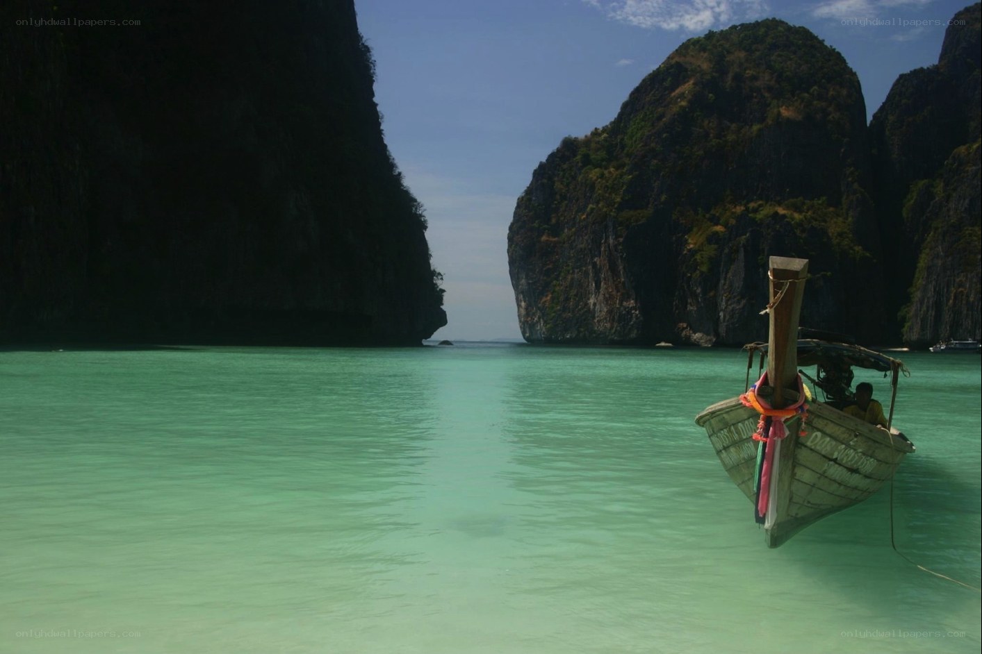 Longtail boat in turquoise waters