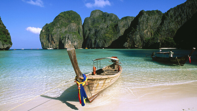 Longtail Boat on Beach — Blue, Serene, Afternoon, Photograph, Cliffs, Sea, Green, White