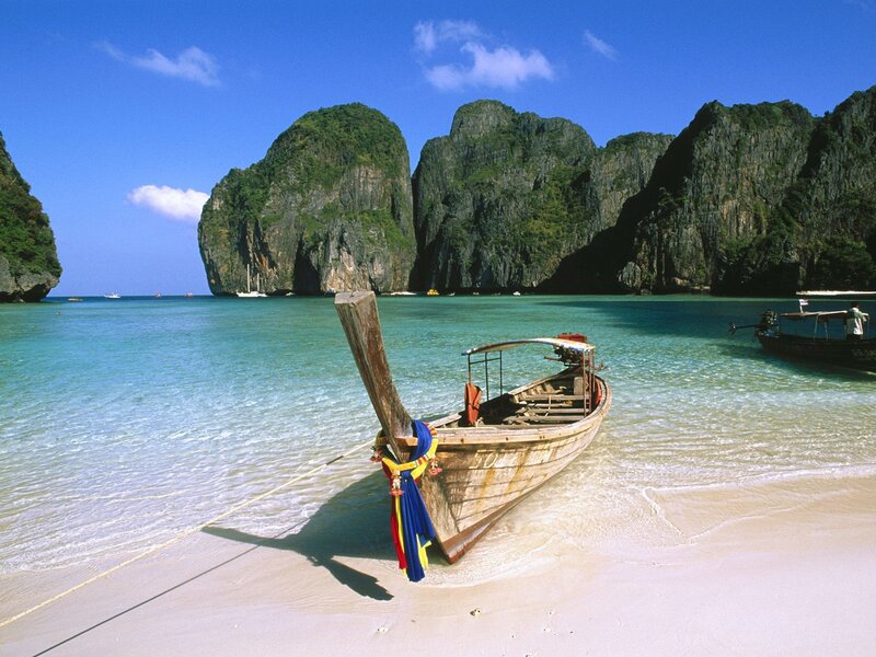 Longtail Boat on Beach — Blue, Serene, Afternoon, Photograph, Cliffs, Sea, Sand