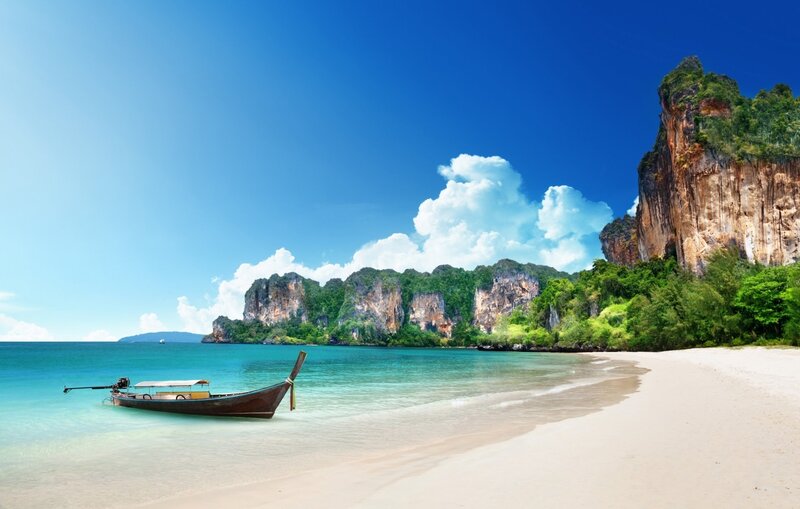Longtail Boat on Beach — Blue, Serene, Afternoon, Photograph, Cliffs, Sea, Sky