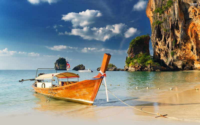 Longtail Boat on Beach — Blue, Serene, Afternoon, Photograph, Cliffs