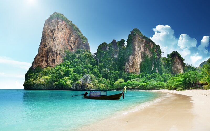Longtail Boat on Beach — Blue, Serene, Afternoon, Photograph, Cliffs, Trees