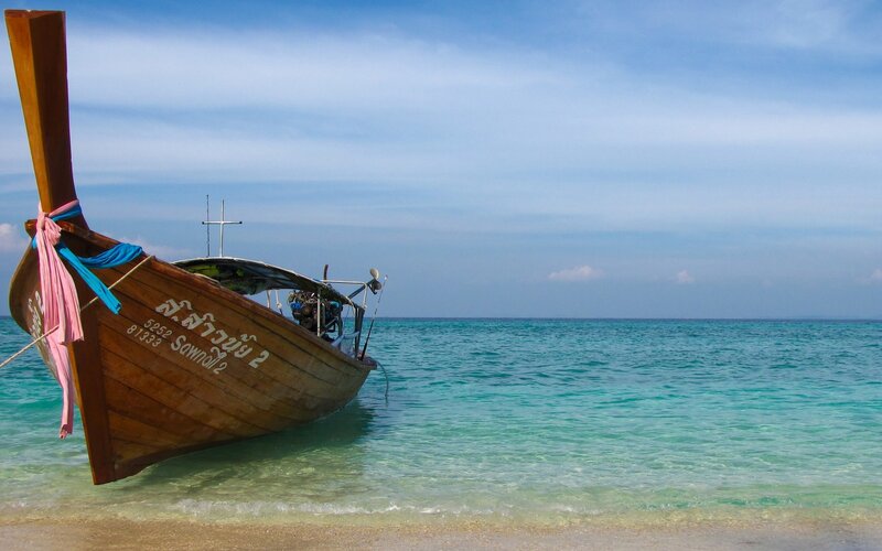 Longtail Boat on Beach — Blue, Serene, Afternoon, Photograph, Ocean, Sky