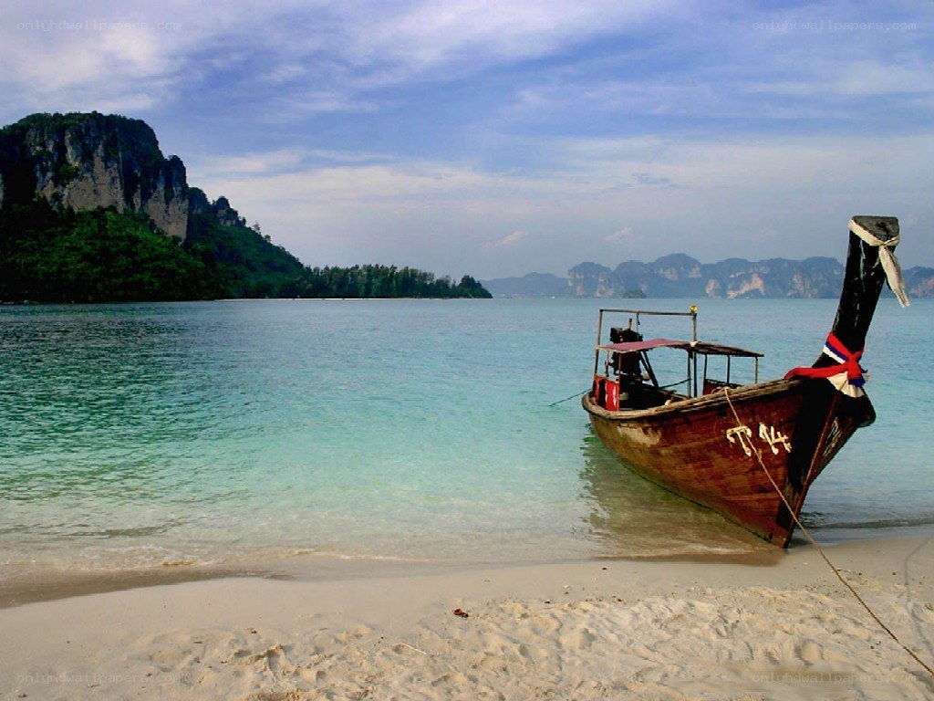 Longtail boat on tropical beach