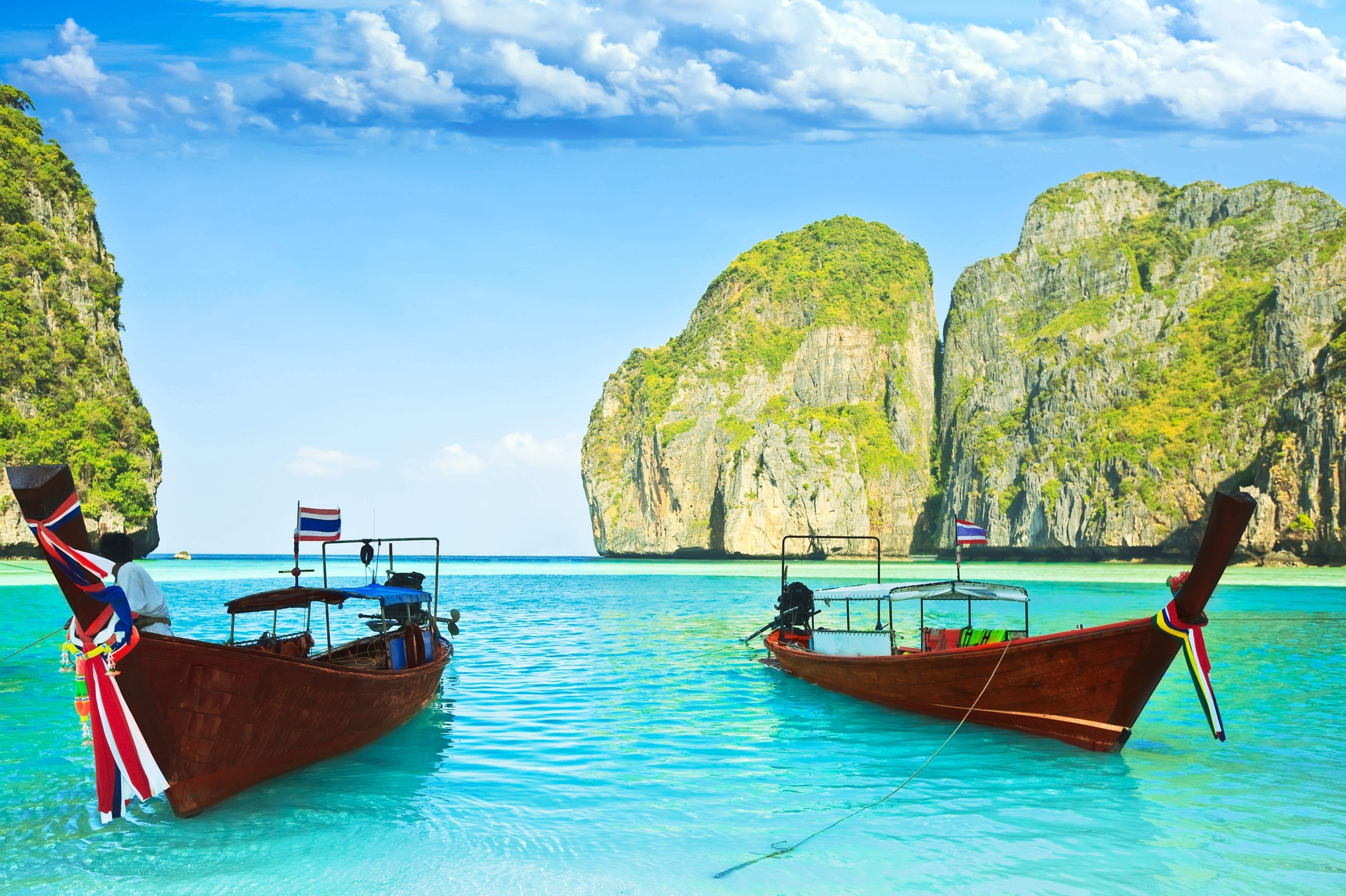 Longtail boats in turquoise bay