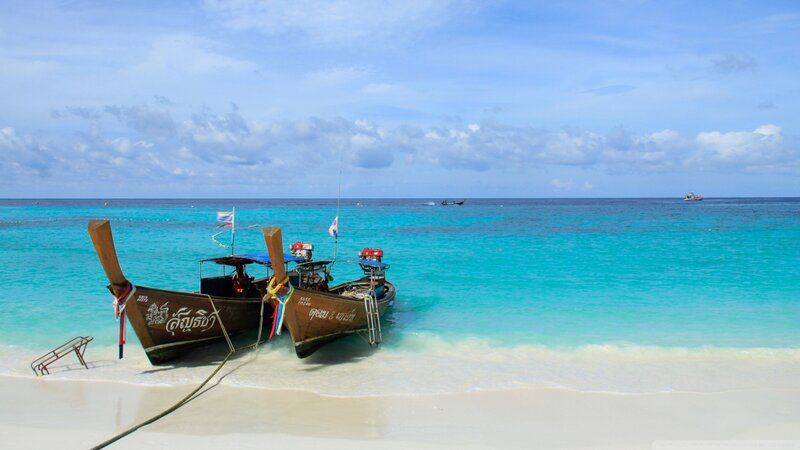 Longtail boats on a tropical beach