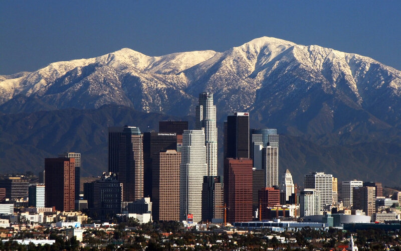 Los Angeles skyline with snow-capped mountains