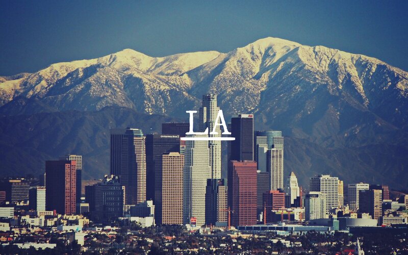 Los Angeles skyline with snow-capped mountains