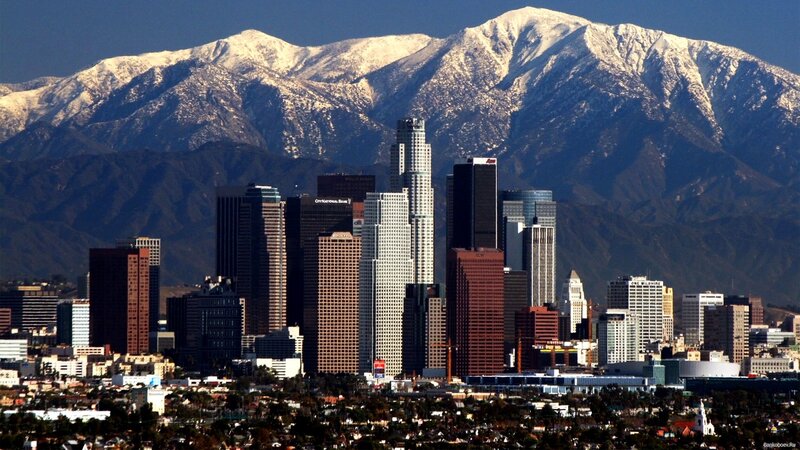 Los Angeles skyline with snow-capped mountains