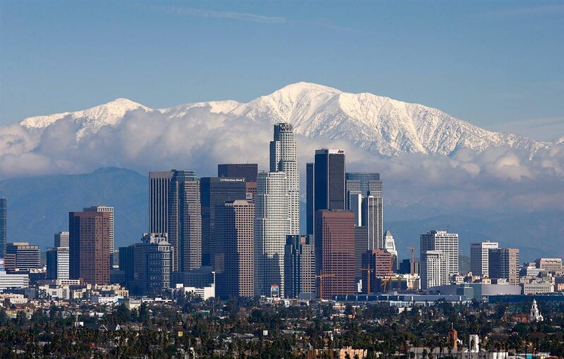 Los Angeles skyline with snow-capped mountains