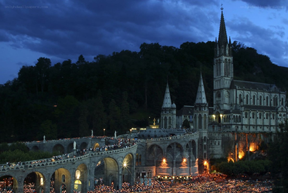 Lourdes pilgrimage at dusk
