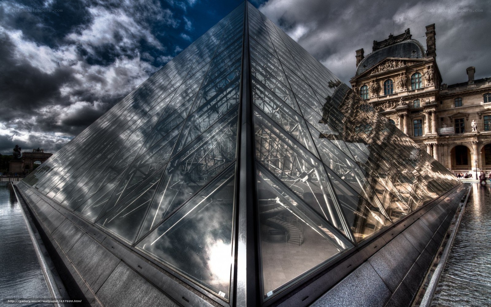 Louvre Pyramid under stormy sky