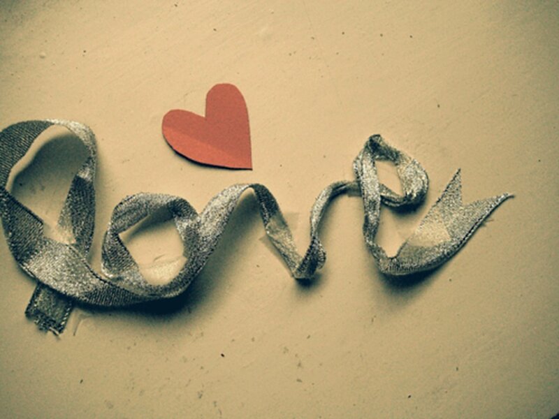 Love spelled with ribbon and heart