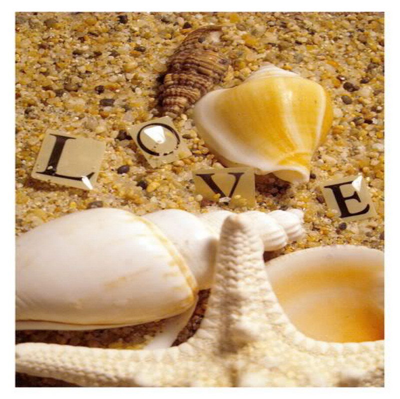 Love spelled with seashells on sand