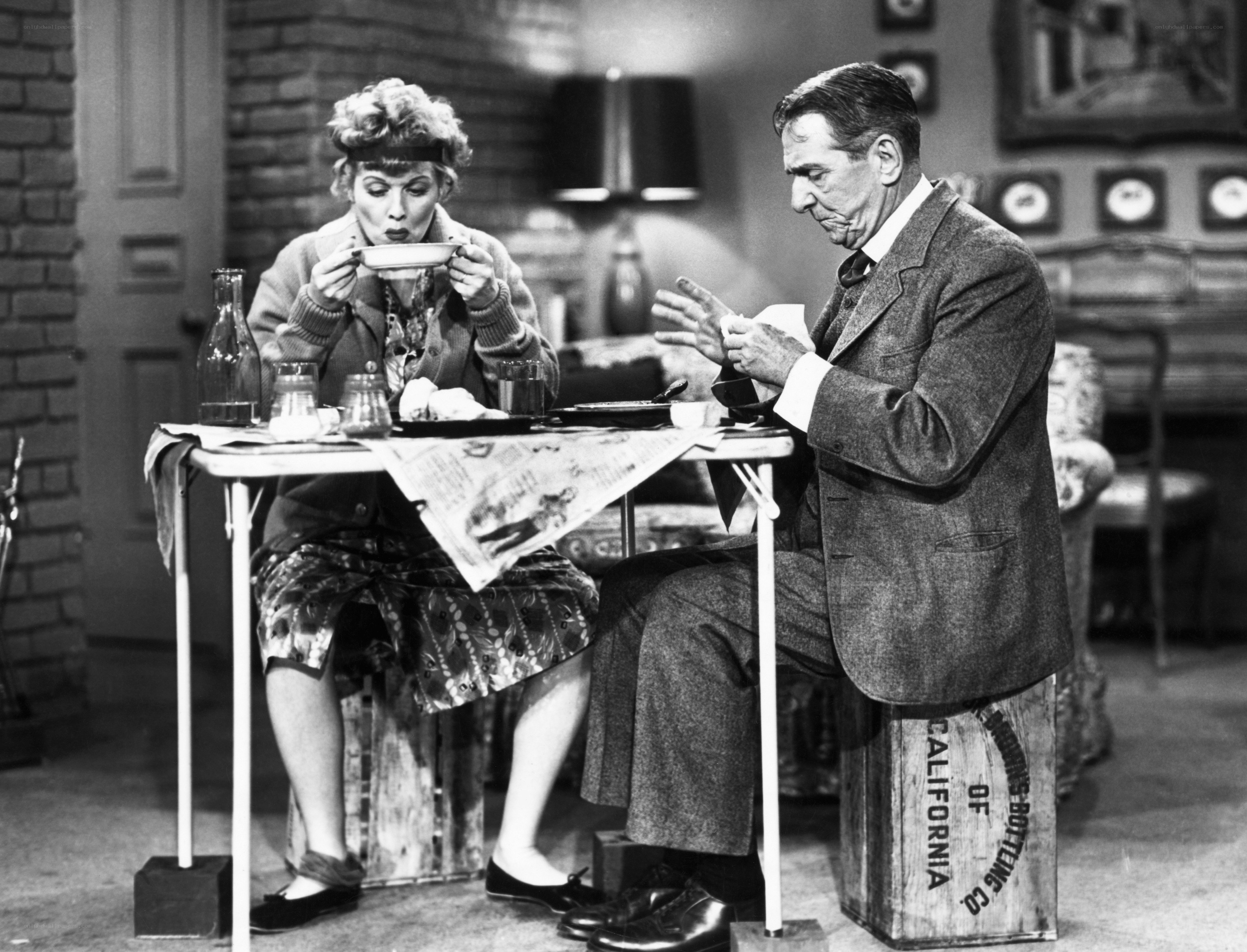 Lucille Ball eating at a table