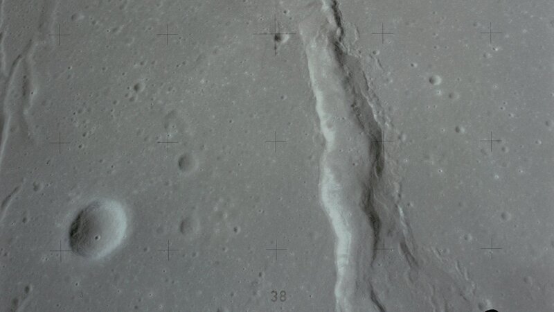 lunar surface with crater and rille