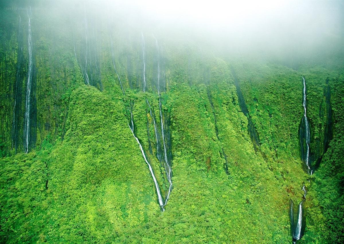 lush green cliffs with waterfalls