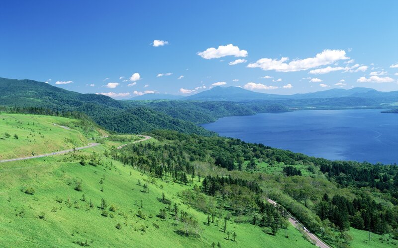 Lush green hills and blue lake