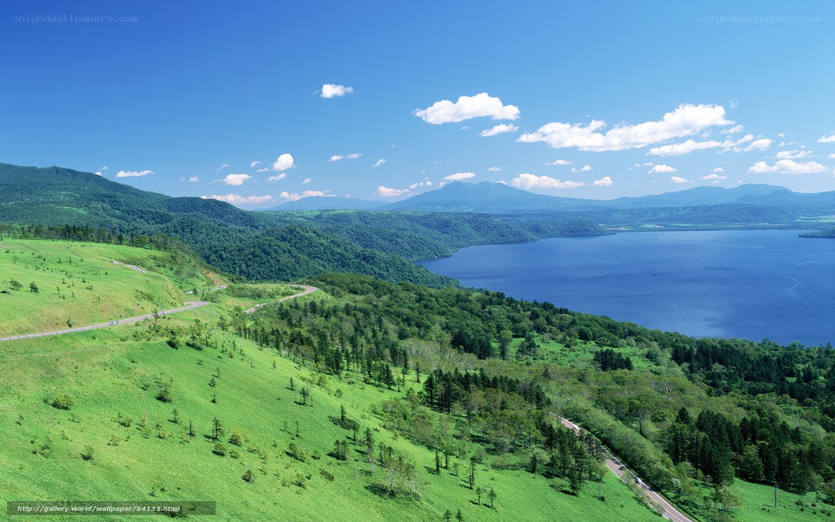Lush green hills and blue lake
