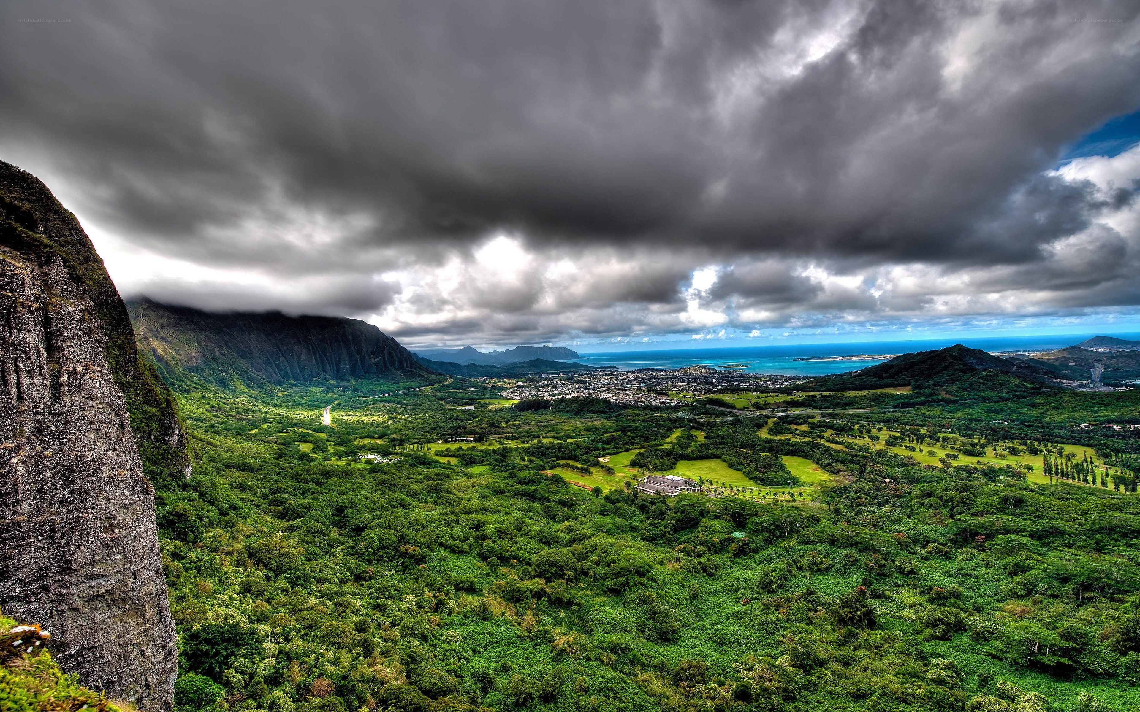 Lush valley under stormy sky