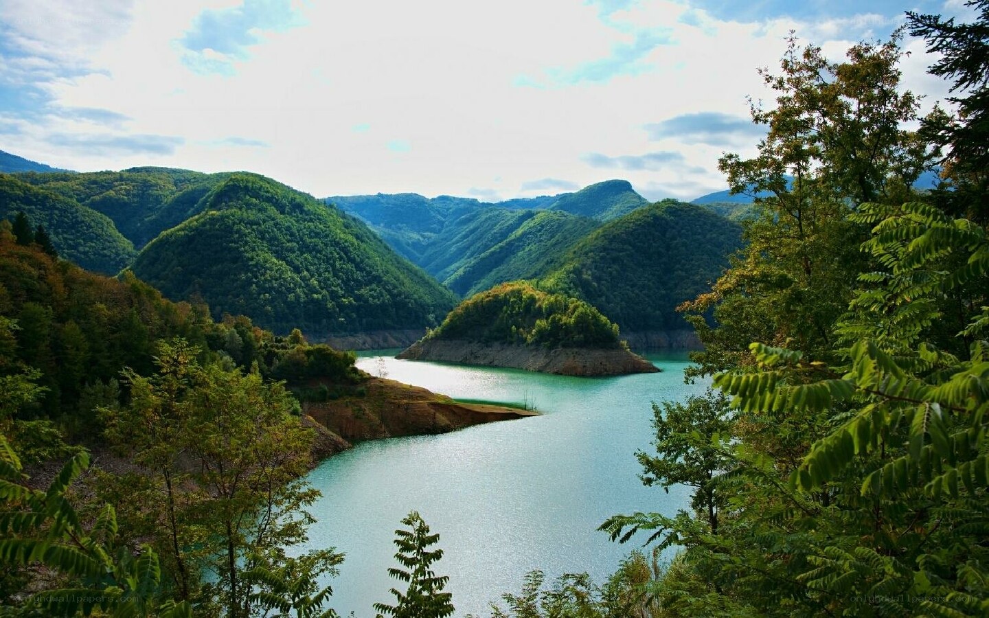 Lush valley with turquoise lake