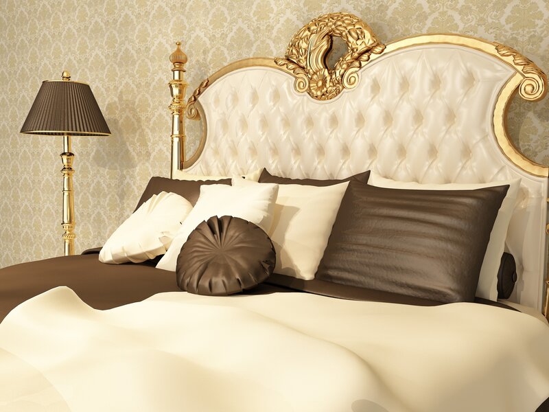 luxury bedroom with ornate headboard
