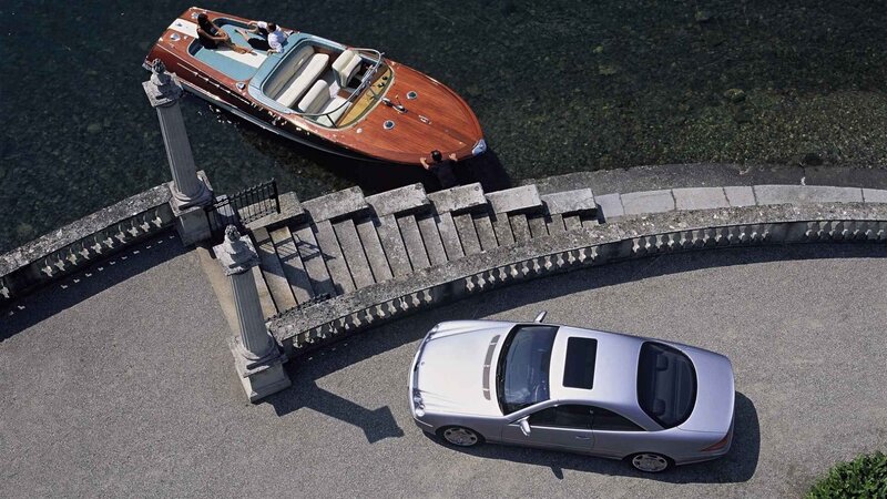 Luxury car and boat at dock