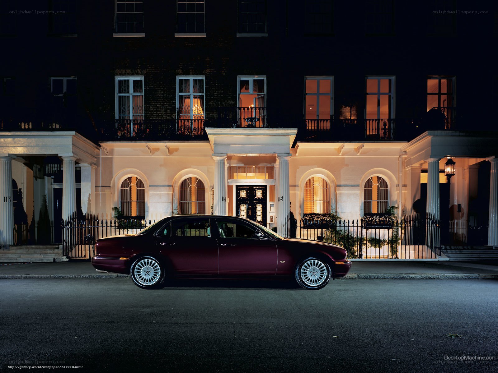Luxury car at night in front of townhouse