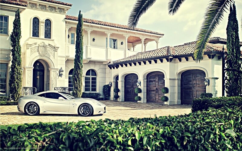 Luxury car in front of mansion
