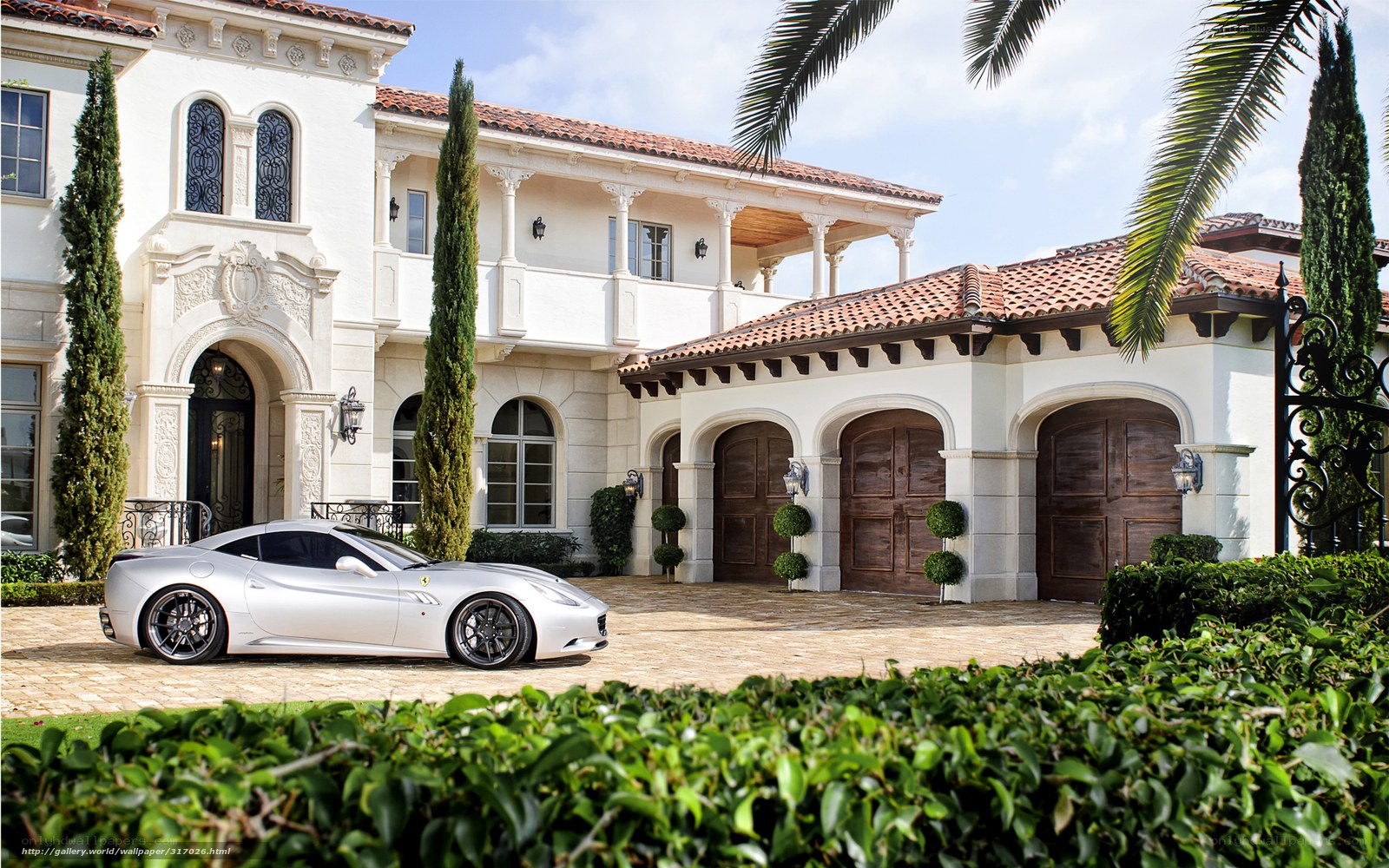 Luxury car in front of mansion