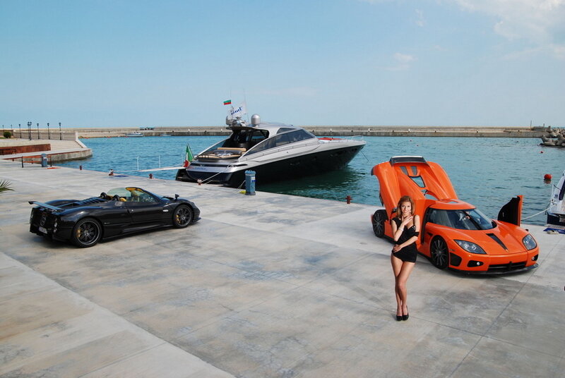 Luxury cars and yacht at marina