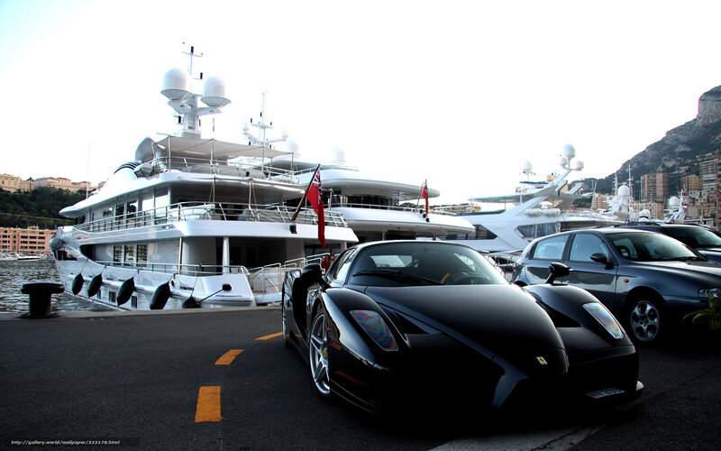 Luxury cars and yachts at marina