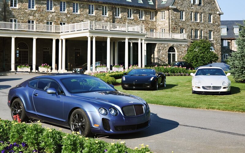 Luxury cars at a stone hotel