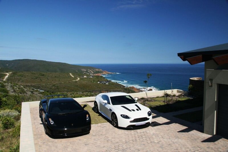 Luxury cars at coastal villa