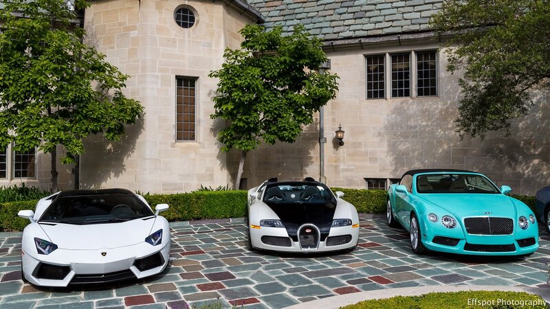 Luxury cars in driveway