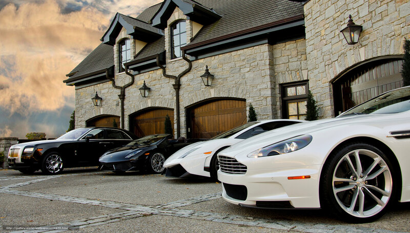 Luxury cars in front of a mansion