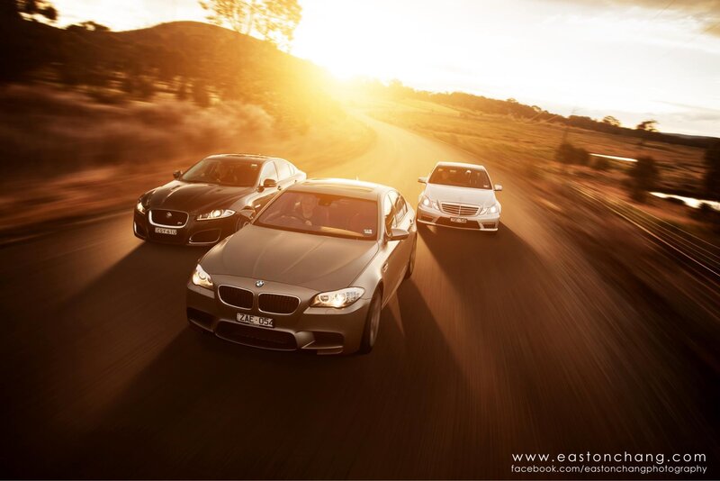 Luxury cars on a scenic road