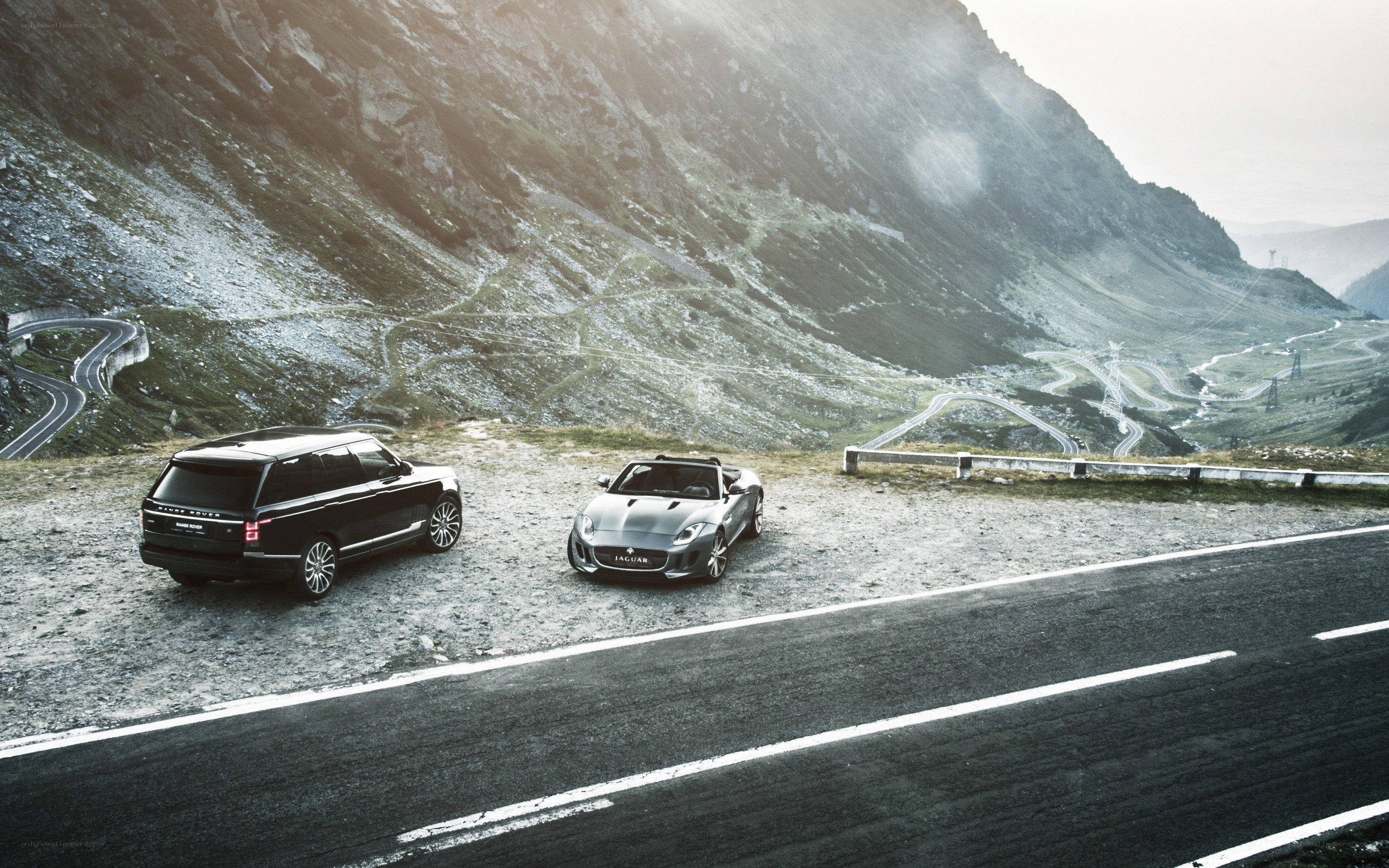 Luxury cars on mountain road
