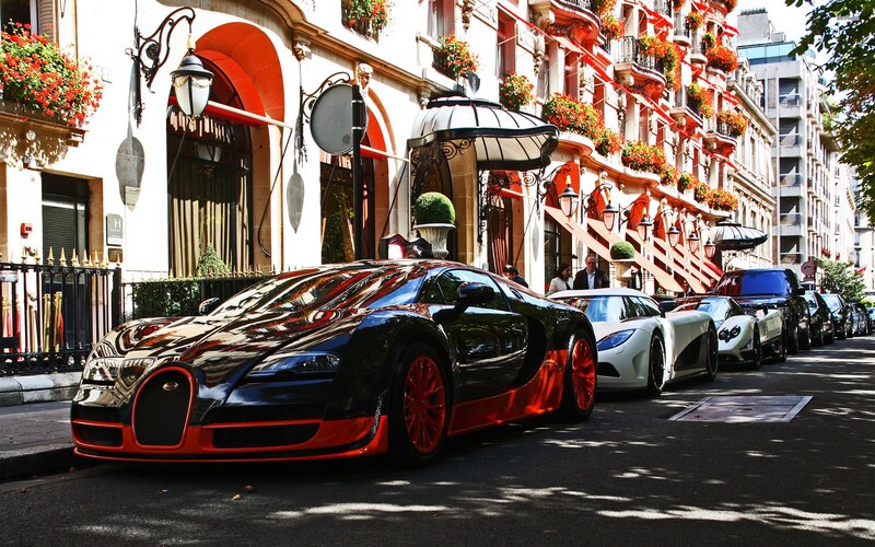 Luxury cars parked on a city street