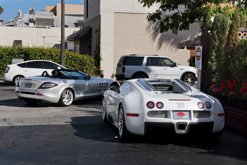 Luxury cars parked on street