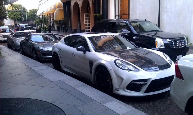 luxury cars parked on street